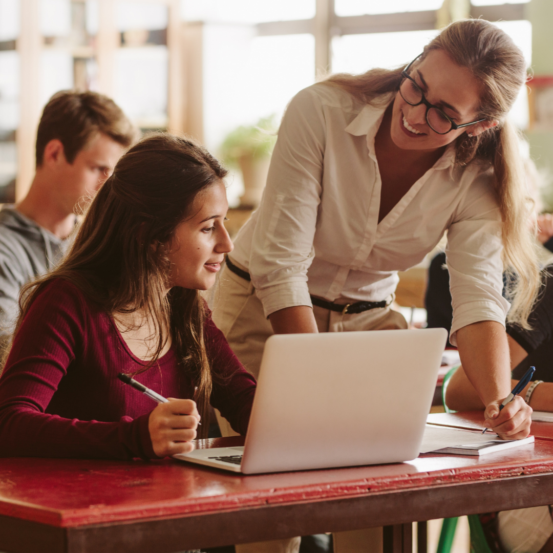 teacher helping student with work